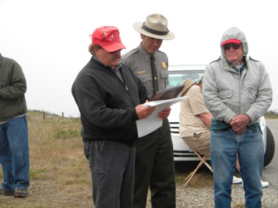 Al Kellogg, Nike Historical Society President, presents a plaque to George Durgerian in appreciation of his work to get the signs installed.