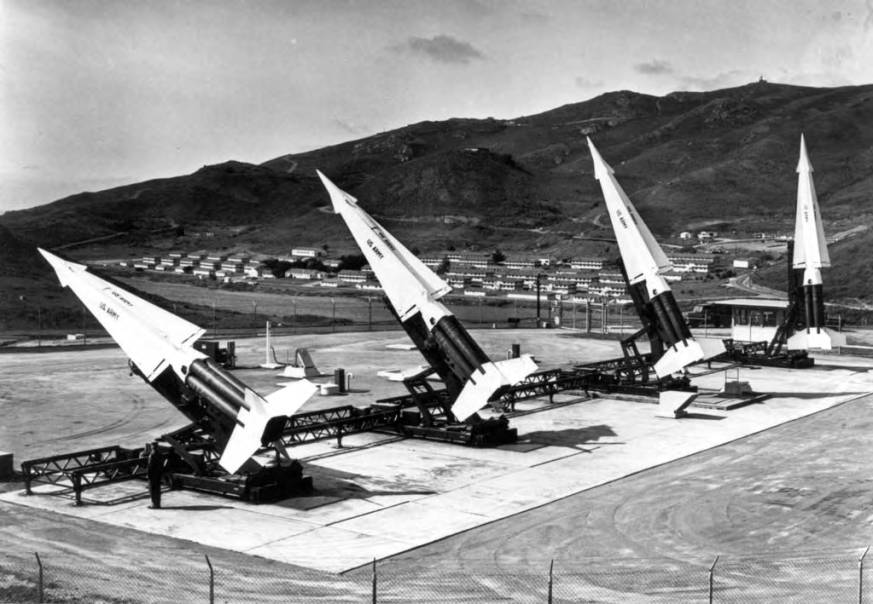 Four Hercules missiles on launchers. Three are partial raised and the fourth is erect.